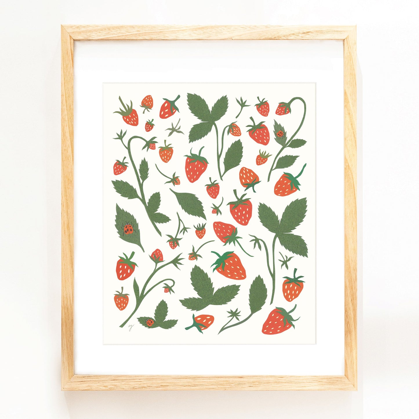 Collage illustration of red and green strawberries with ladybugs on the leaves. Framed in a beautiful wood frame.